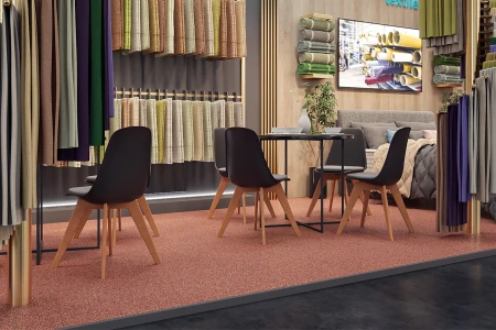 I prodotti tessili Heimtextilien per la casa sono presentati in un elegante stand espositivo. Il pavimento espositivo WARCO, coordinato per colore, è costituito da lastre a clip in granulato di gomma.