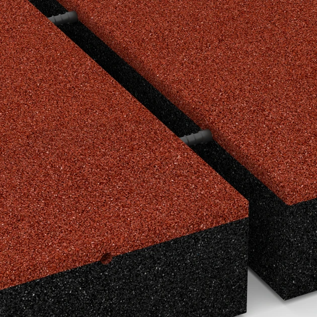 Le gros plan sur le système de connexion des revêtements de sol WARCO 6278 - Dalle amortissante – 300 cm en couleur Rouge brique. Les dimensions 50 x 50 x 11 cm.